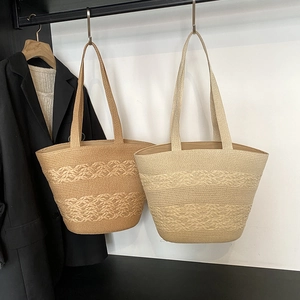 Summer straw tote bag with woven wave pattern in brown and beige colors