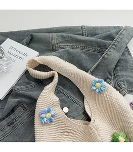 Détail du sac tricoté avec fleurs 3D et bandoulière large confortable et souple