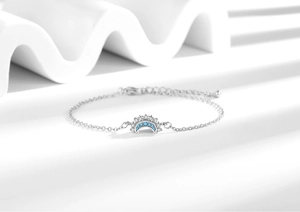 Detail of sun and moon couple bracelet with blue cubic zirconia and silver finish