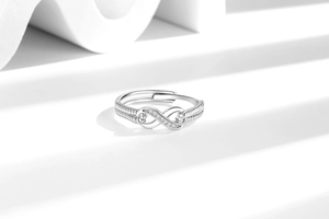 Detail of adjustable infinity ring featuring sparkling crystals and textured band