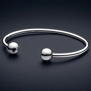 Minimalist stainless steel open bangle with double polished metal spheres in silver