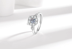 Macro detail of rotating lucky cat ring with flower halo and sparkling crystal stones