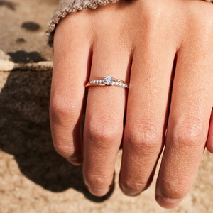 Elegant rose gold geometric ring with cross-over band design and sparkling zircon pavé