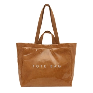 Large brown waterproof tote bag with TOTE BAG white lettering and woven shoulder straps
