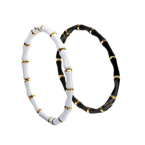 Minimalist bamboo style enamel steel bracelets in black and white with gold accents