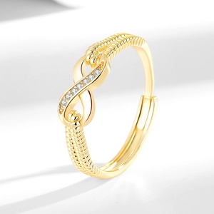 Elegant gold infinity ring with twisted band and pavé set cubic zirconia accents