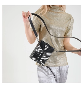 Detail shot of mini box crossbody bag with zebra pattern and creative suit collar design