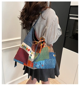 Detailed back view of a large bohemian quilted canvas tote bag with floral patchwork patterns