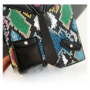 Macro shot of colorful snake pattern leather with black tie design and silver hardware