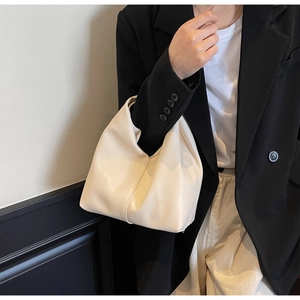 Minimalist cream leather handbag with elegant pleated design for professional women