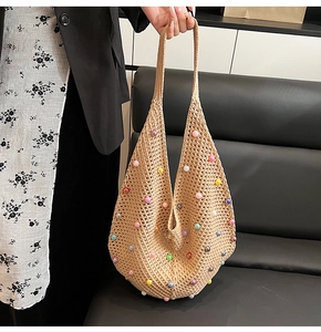 Detail of hand-woven mesh shoulder bag with vibrant multi-colored decorative beads