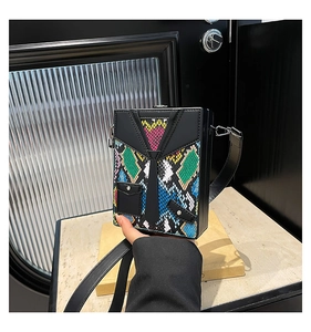 Detail of creative suit-style square box bag with snake pattern and 3D tie design
