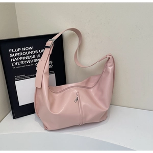 Gros plan du sac hobo rose en similicuir lisse avec détail de fermeture éclair latérale