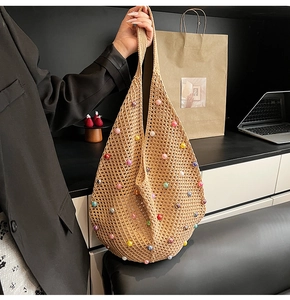 Detail of bohemian knit tote bag featuring colorful pearl beads and a woven texture