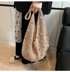 Detail of knit crochet tote bag featuring vibrant colorful pearls for beach vacations