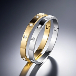 Polished titanium steel clover bangles with inlaid crystals in gold and silver finish