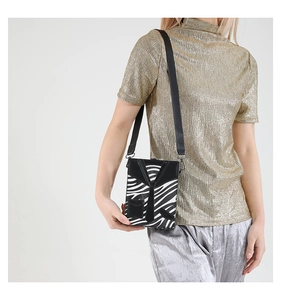 Detail of creative zebra pattern mini bag featuring a black suit collar and tie design