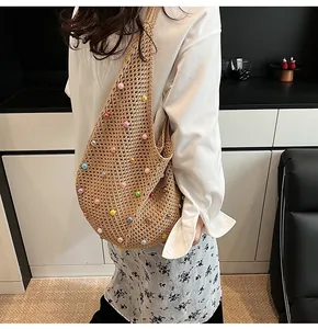 Close-up of beige knit shoulder bag featuring colorful macaron pearl embellishments