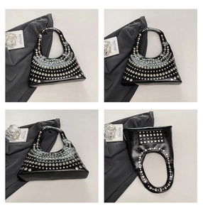 Detail view of black crescent hobo bag with silver studs and polished faux leather