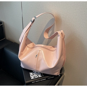 Détail d'un grand sac cabas rose pâle en simili cuir avec texture brillante et bandoulière