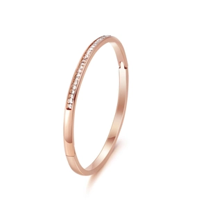 Detailed close-up of a rose gold titanium steel bracelet with pavé square-cut crystals