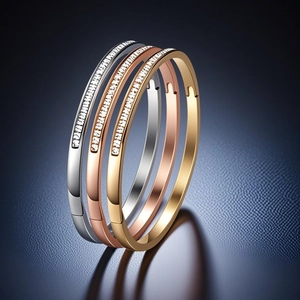 Close-up of three stacked titanium steel bangles featuring fine diamond encrusted details