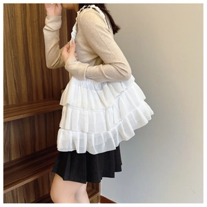 Detail of white layered ruffle tote bag made of light chiffon with pleated design