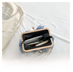 Blue tweed evening bag interior showing capacity for smartphone and lipstick