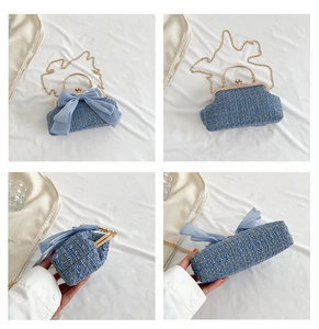 Detail view of blue tweed crossbody bag with a large chiffon bow and metal clasp