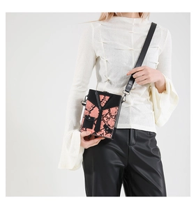 Detail of snake skin pattern box bag featuring a creative blazer collar and tie design