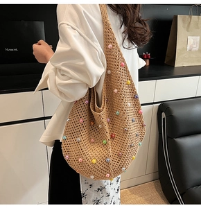 Detail of hand-woven hollow tote bag with colorful beads and wide shoulder strap