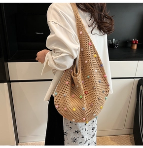 Detail of bohemian hollow knit tote bag featuring colorful pearl accents and woven texture