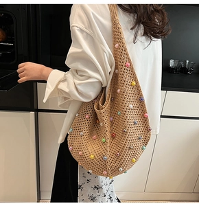 Close-up of hand-knitted crochet mesh bag with colorful pearls and earthy tones texture
