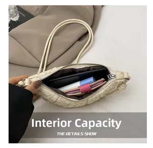 Internal capacity of woven crossbody bag holding phone, lipstick and small wallet