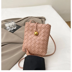 Detail of pink woven leather mobile phone bag with golden spherical buckle and strap