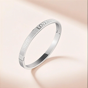 Silver stainless steel love bangle with matte frosted texture and engraved letters