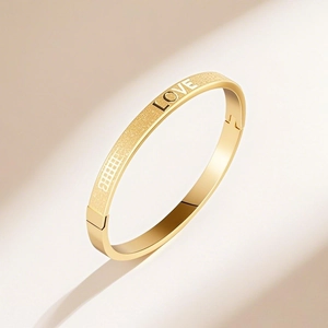 Gold stainless steel LOVE engraved bangle with matte sandblasted and polished finish