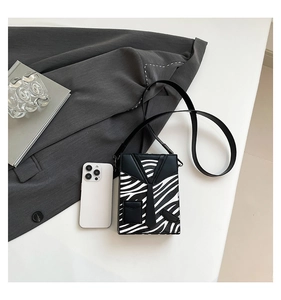 Close-up of zebra pattern box bag featuring creative suit collar and tie design detail