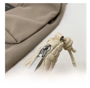 Detailed macro view of the silver metal zipper and premium woven leather texture on bag