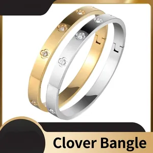 Classic stainless steel open bangle with lucky clover pattern and inlaid cubic zirconia