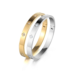 Polished titanium steel bracelets with rhinestone flower accents in gold and silver set