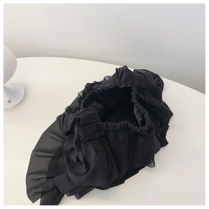 Close-up of black layered ruffle pleats and elastic opening on a sweet tote bag