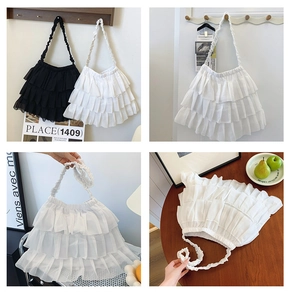 Detail of layered ruffle chiffon shoulder bags in black and white with pleated handles