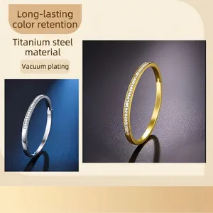 Titanium steel bangles in gold and silver finish with pavé set zircon crystals