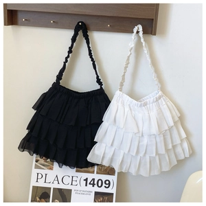 Detail of ruffled chiffon shoulder bags in black and white with multi-layered pleated frills