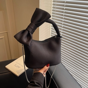 Elegant black nylon pillow bag with oversized bow and silver chain for women