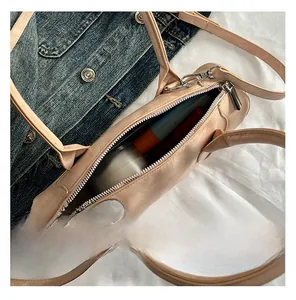 Detailed interior view showing large storage capacity and zipper of the beige Boston bag