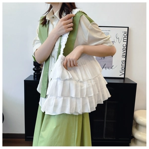 Close-up of white layered ruffle tote bag with delicate pleated chiffon fabric details