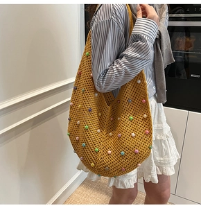 Detail of hand-woven ginger hobo bag with colorful pearls and thick cotton mesh texture