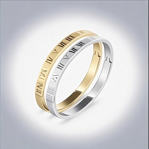 Detail view of gold and silver roman numeral engraved stainless steel bangles